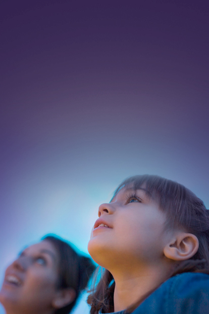 Photo of children looking to the sky.